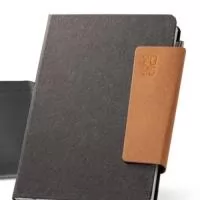 A agenda em couro reciclado com fecho magnético é um brinde corporativo sofisticado e sustentável, perfeito para presentear clientes e colaboradores. Com suporte para esferográfica e marcador em fita, ela é prática e funcional para uso no dia a dia. Acompanha bolsa de non-woven para proteção e transporte. Personalize com a logomarca da sua empresa e ofereça um presente exclusivo e elegante.