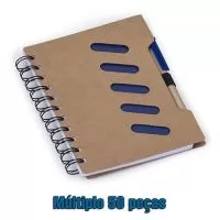 Tamanho 15,8 cm x 13,2 cm.Bloco de anotações ecológico com caneta reciclada. Possui cinco detalhes vazados na capa e verso liso, espiral preto,suporte elástico com caneta de papelão de clip e ponteira plástica. Tem aproximadamente 70 folhas brancas pautadas. 