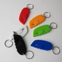 Chaveiro estilete. Sem trava, sendo necessário segurar o botão durante o uso.