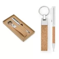 Conjunto composto por uma caneta esferográfica e um chaveiro, ambos em metal e cortiça. A caneta esferográfica tem clipe em metal, mecanismo twist e escrita em azul. Fornecido em caixa presente de papel kraft reciclado. 