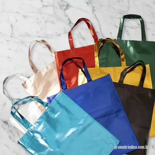 Sacola de TNT metalizado personalizada - Descrição: Sacola confeccionada em TNT com revestimento externo laminado e duas alças costuradas.  Altura :  50 cm  Largura :  45 cm  Profundidade :  11 cm  Medidas aproximadas para gravação (CxL):  45 cm x 40 cm