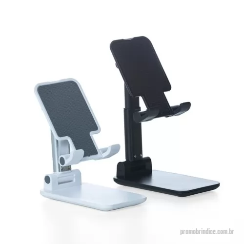 Suporte de Mesa para Celular e Tablet personalizado - Suporte retrátil para celulares e tablets. Produzido em plástico com haste de alumínio, o suporte possui ângulo ajustável e extensão de altura. Seu tapete de silicone antiderrapante garante a estabilidade do eletrônico sem machucar sua traseira. As “canaletas” também revestidas de silicone encaixam perfeitamente ao eletrônico sem bloquear a visualização da tela, além do espaçamento ideal que permite o carregamento do celular/tablet no suporte sem bloquear a visão ou atrapalhar sua estadia. Com base de silicone antiderrapante, o suporte permanece fixo e estável nas mais diversas superfícies.